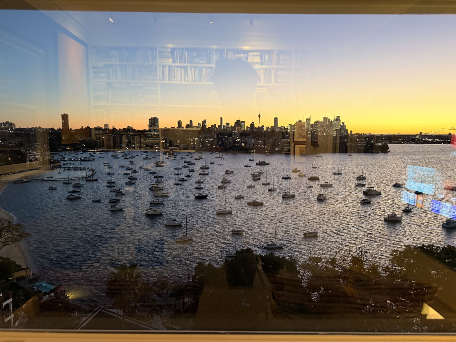 Harbour and city skyline at sunset through the window
